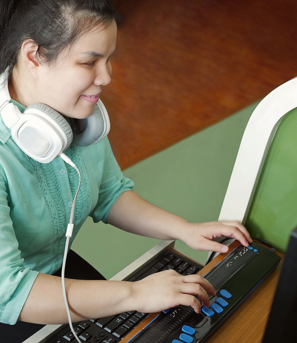 Asian,Young,Blind,Person,Woman,With,Headphone,Using,Computer,With
